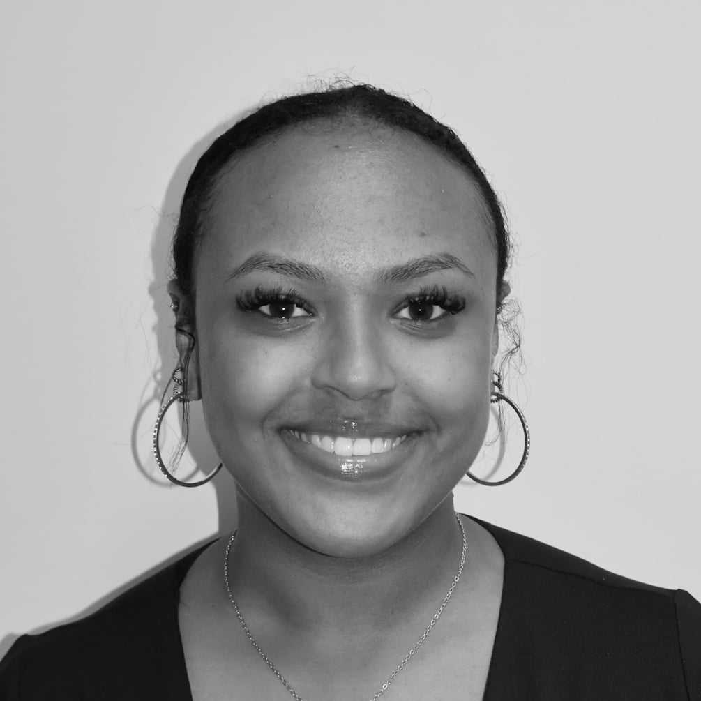 Portrait of America G, a professional stylist at Cameo Salon & Spa, showcasing their expertise and style.