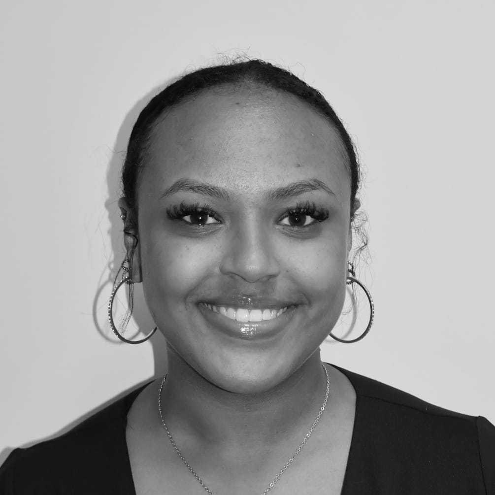 Portrait of America G, a professional stylist at Cameo Salon & Spa, showcasing their expertise and style.